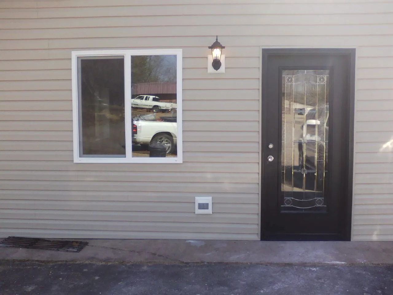 New siding, window and entry door on the side of an addition in Severance